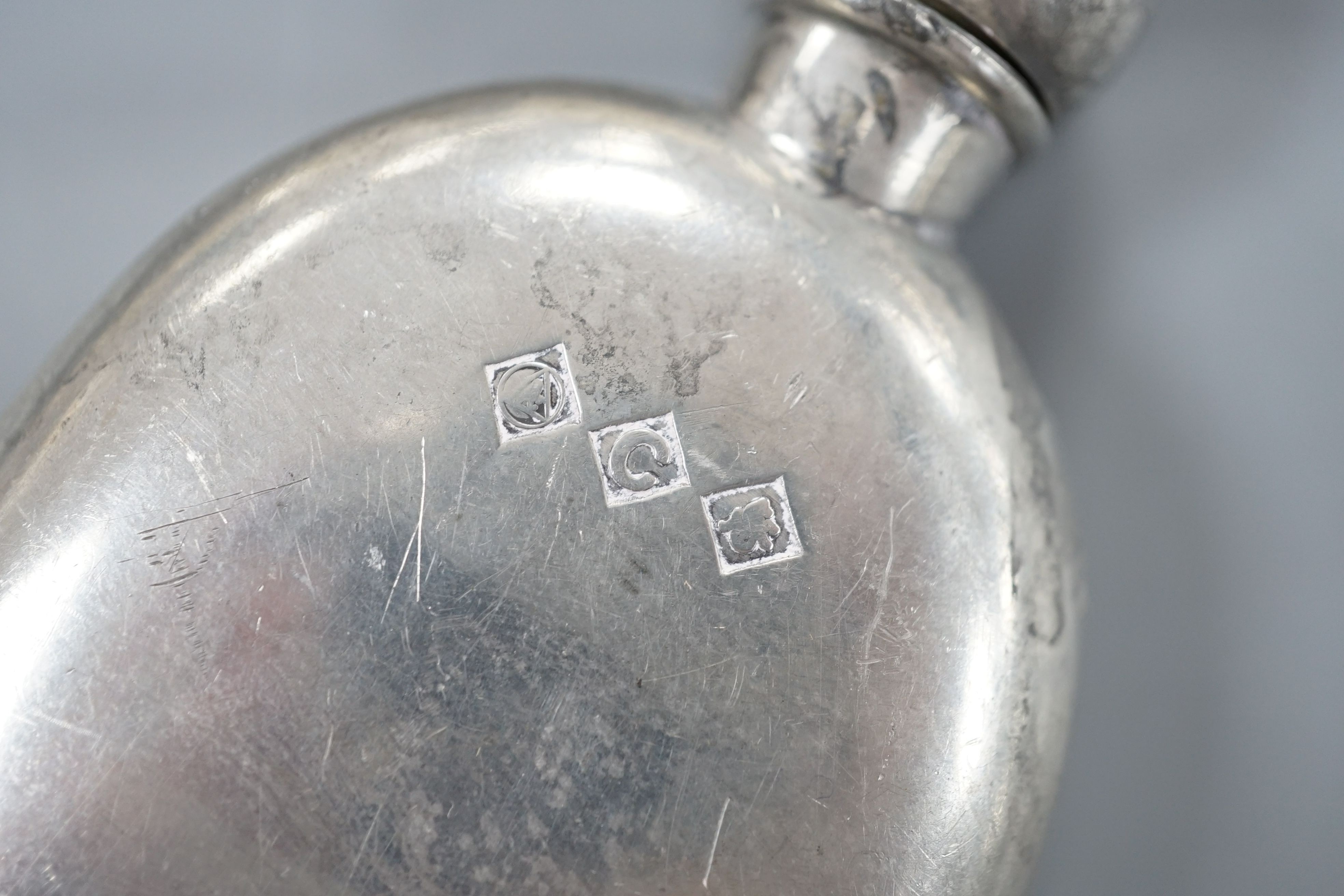 A cased pair of George V silver preserve spoons, Sheffield 1911, 36 grams, an ingot pendant, 15 grams and a pewter pocket flask